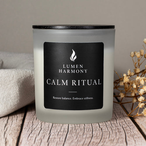 Candle labeled 'Lumen Harmony Calm Ritual' on a wooden surface with a neutral background