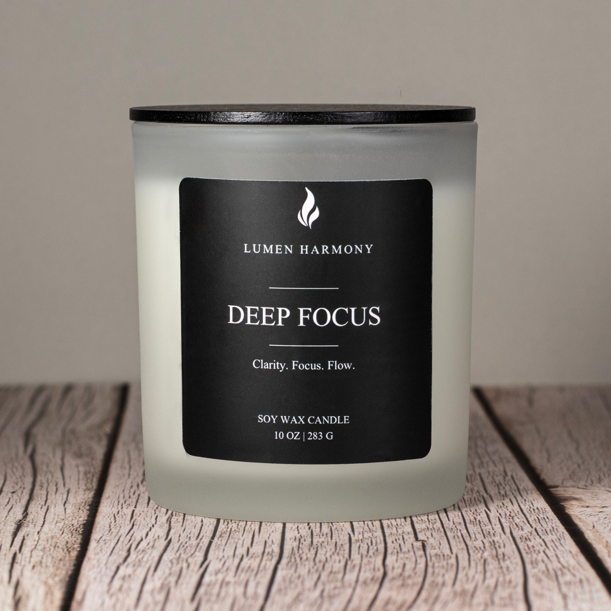 Lumen Harmony Deep Focus candle on a wooden surface with a neutral background