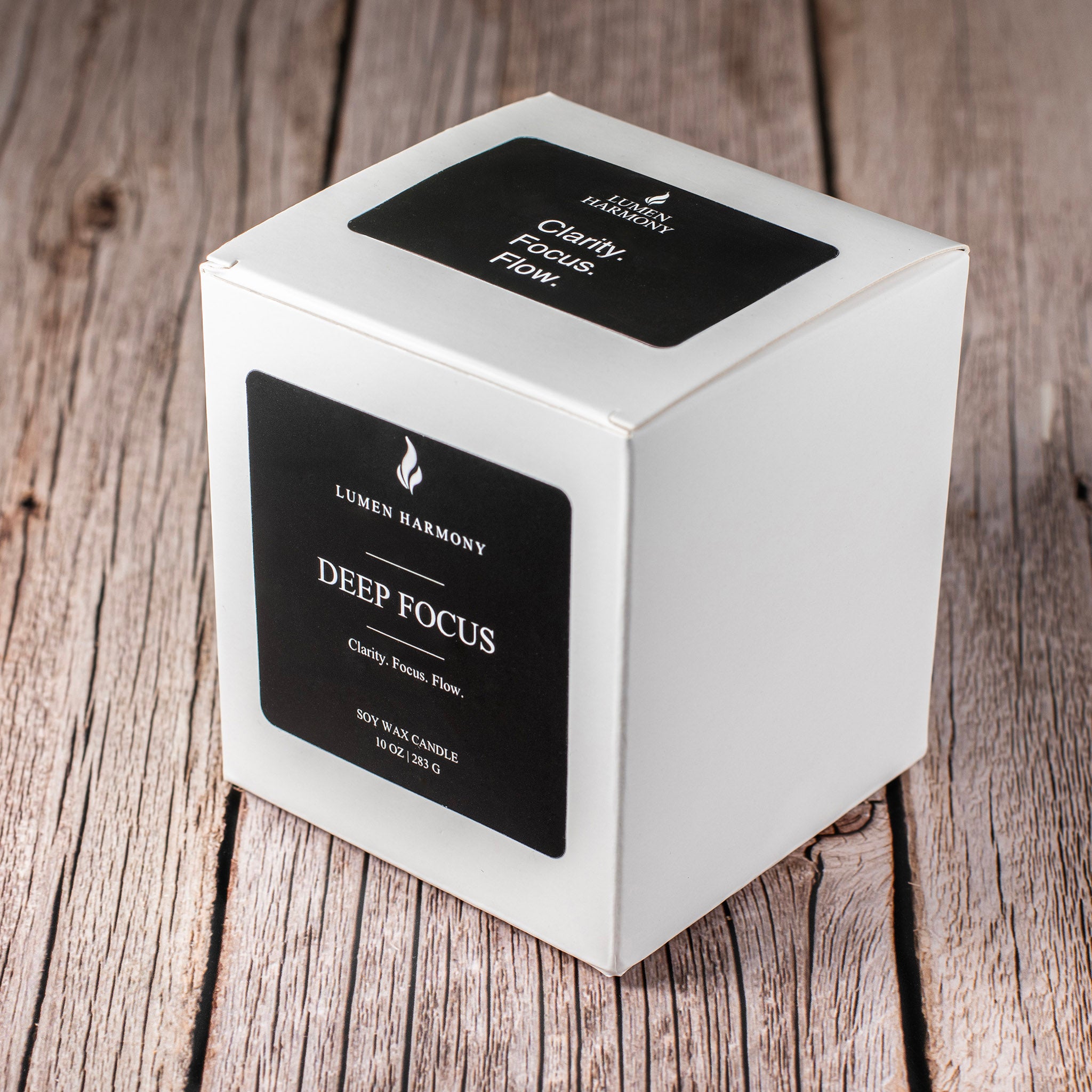 Lumen Harmony candle packaging on a wooden surface