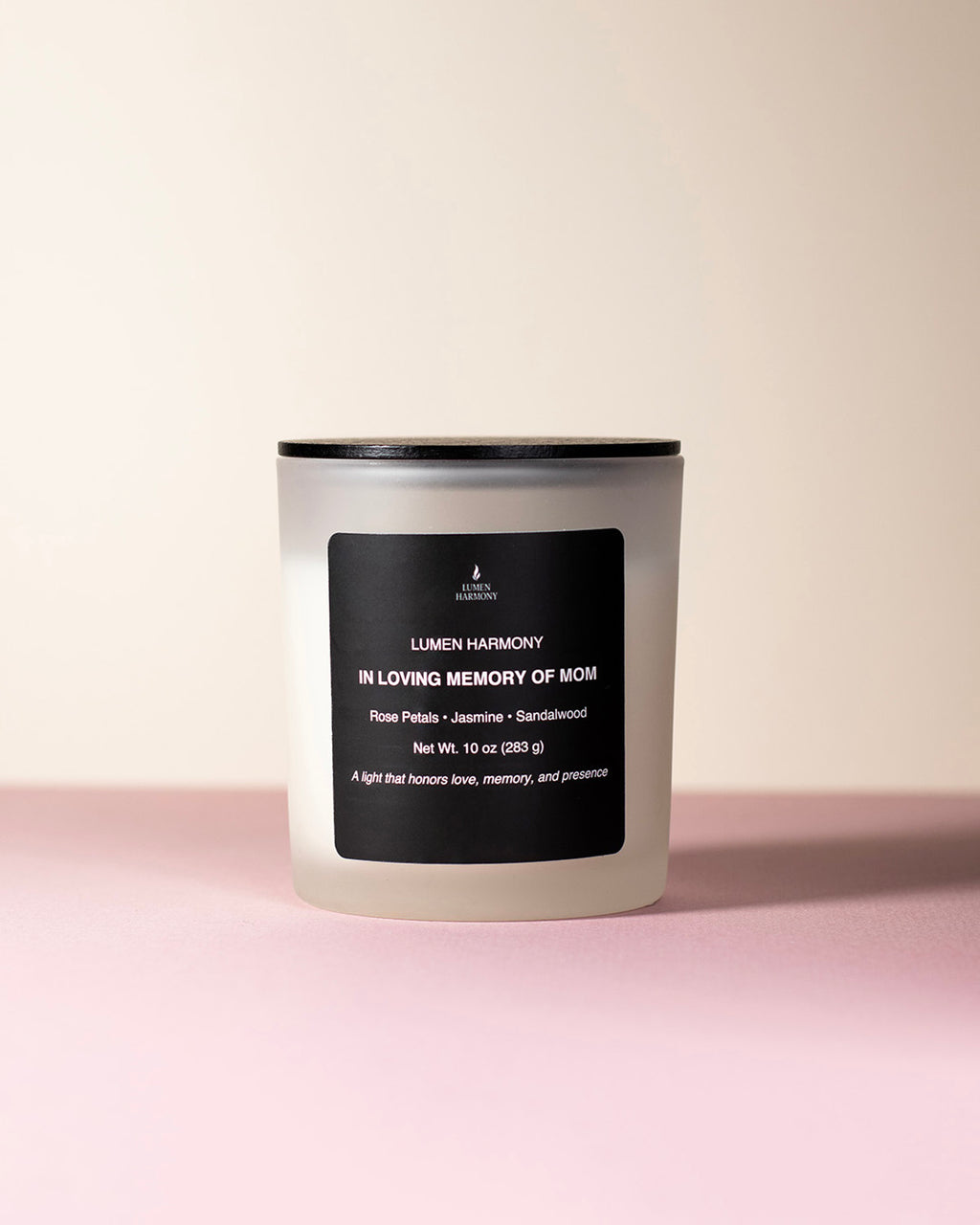 A candle called "in loving memory of Mom" over a neutral background