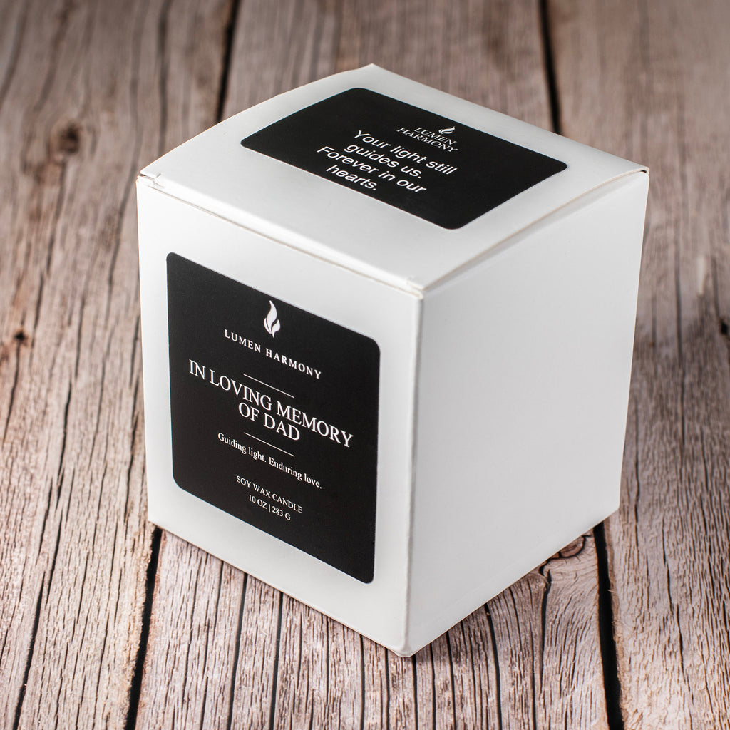 White candle box with black label on a wooden surface