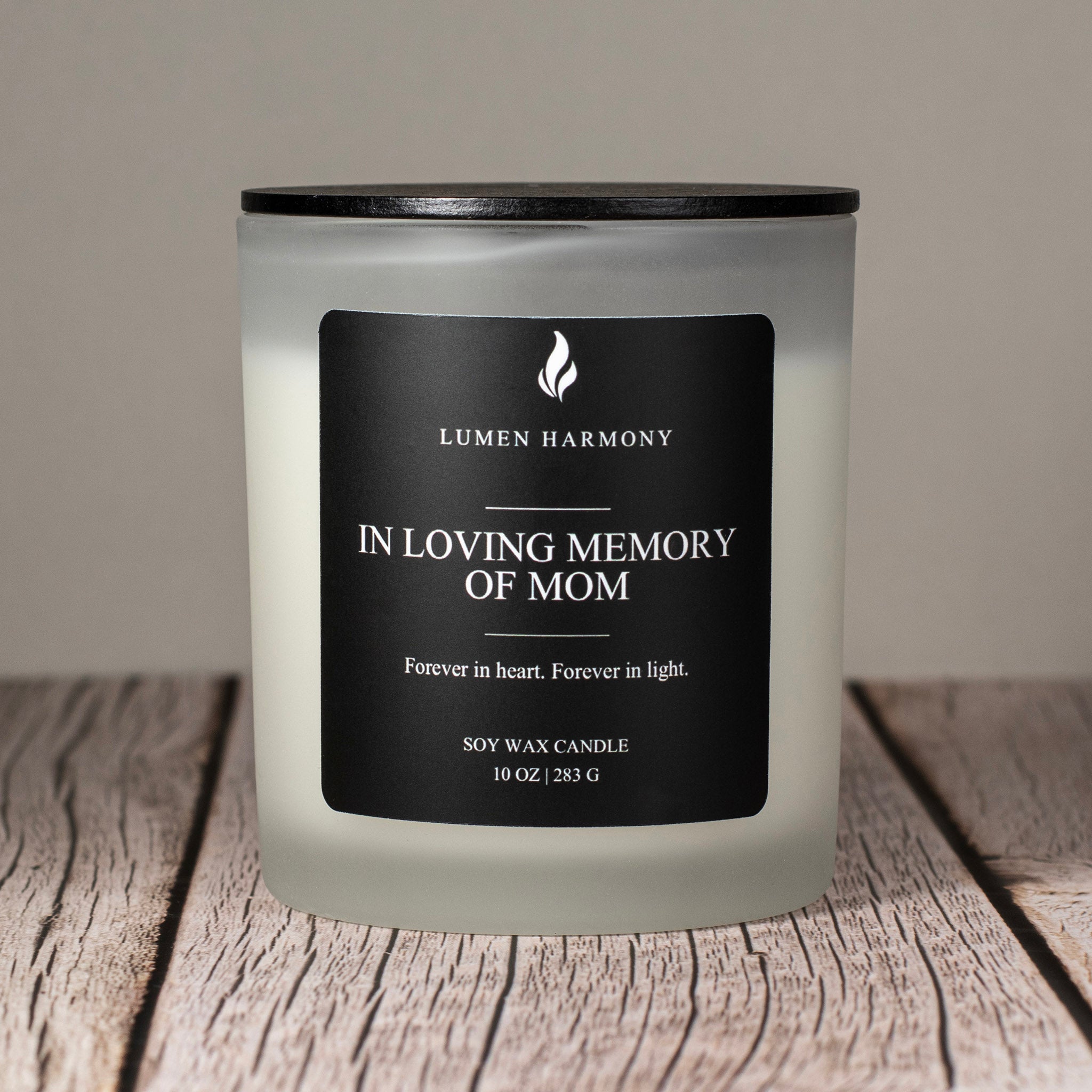 Lumen Harmony Candle with a label on a wooden surface, featuring the brand 'Lumen Harmony'.