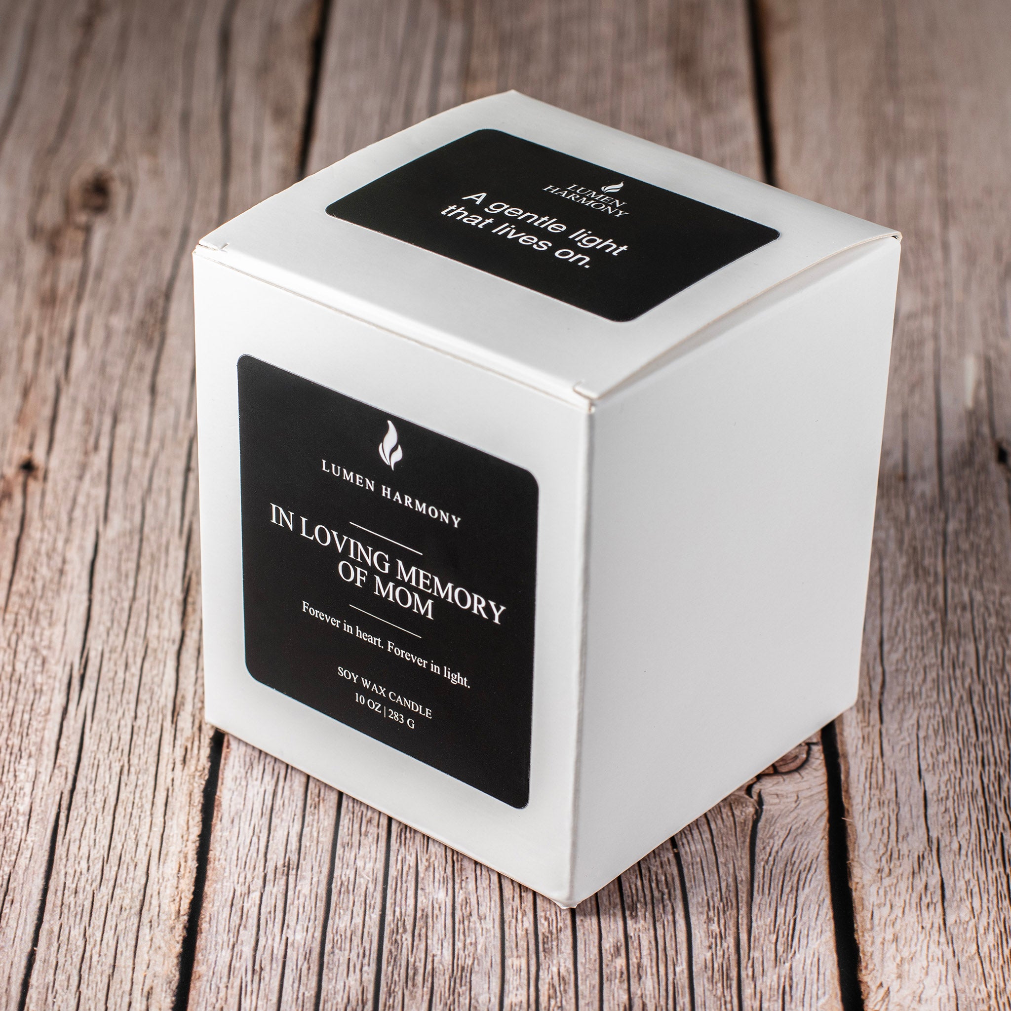 Candle packaging with 'Lumen Harmony' branding on a wooden surface