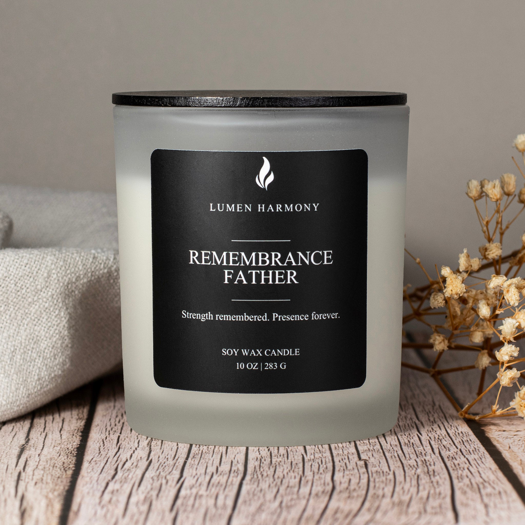 Frosted candle with black label on a wooden surface, featuring 'Lumen Harmony' brand.