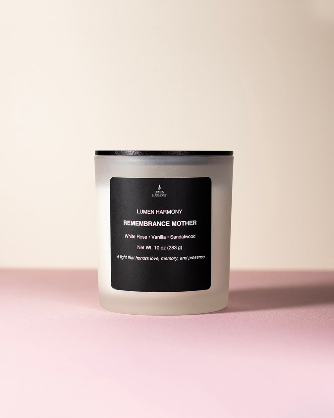 A candle called "Remembrance Mother" in a pastel color background