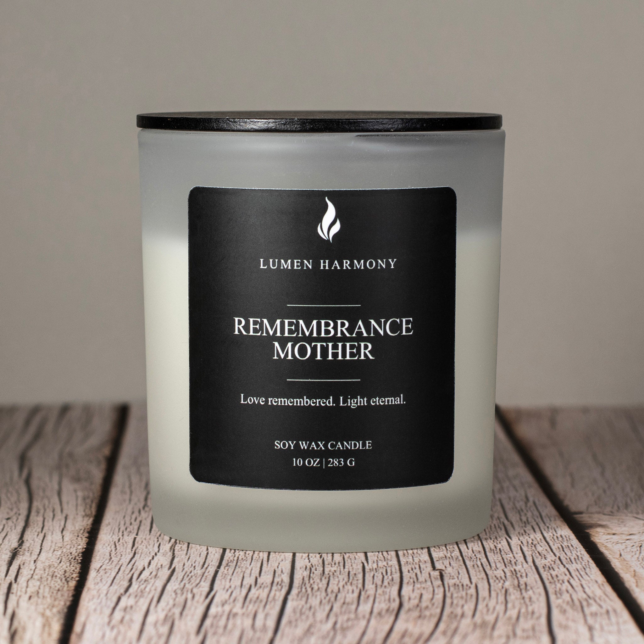 Lumen Harmony Candle with a black label on a wooden surface